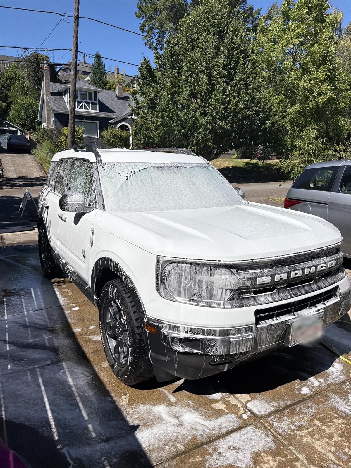 Ford Bronco covered in foam in a driveway
